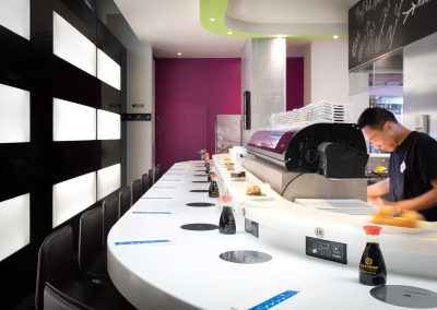 counter of a sushi restaurant with a conveyer belt