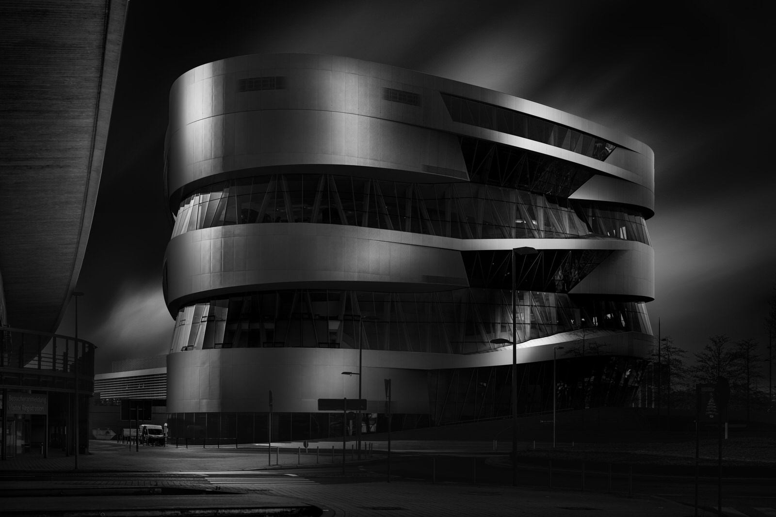 side view of the mercedes benz museum in stuttgart with clouds in the background