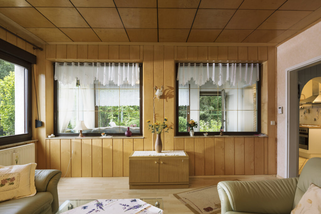 Living room with wood paneling in a small house